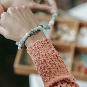 Unrecognizable woman trying on handmade bracelet